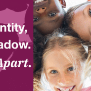 Image of children in a circle, smiling at the camera below, with the caption "My Identity, My Shadow. Never Apart."
