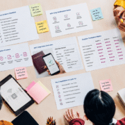 In bird's eye view, a group of people at a table are looking at paperwork related to choosing an ID chip verification provider.